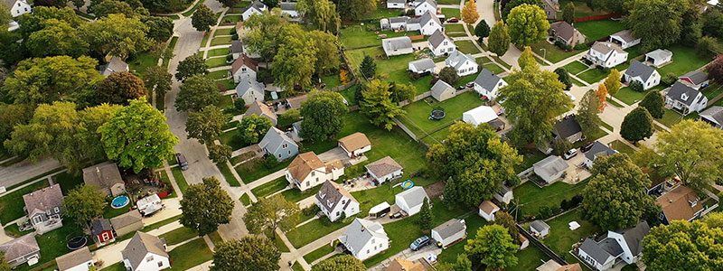 an aerial view of a lush green neighborhood